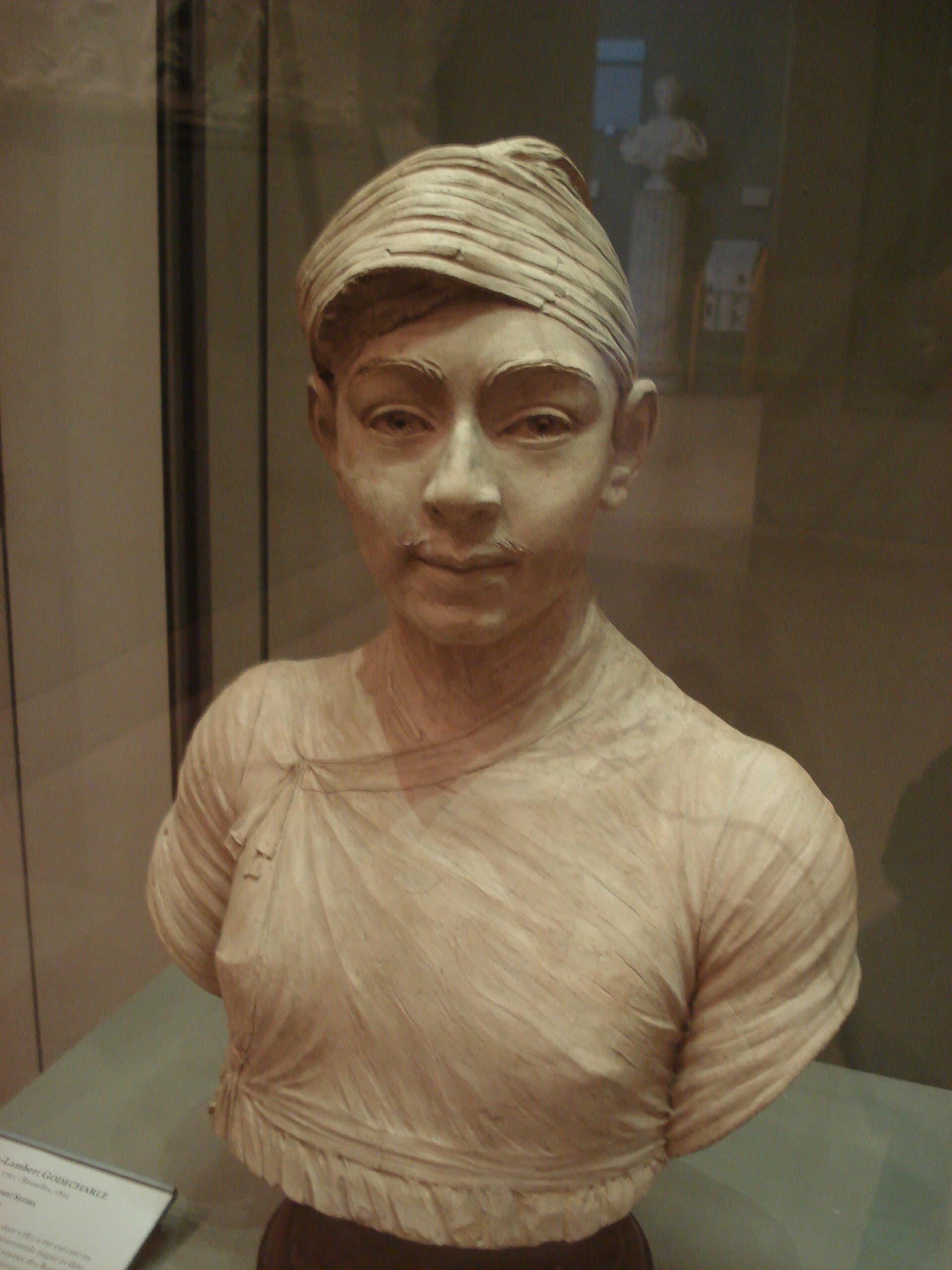 Marble portrait bust of a young man in a turban, carved in the neoclassical manner.