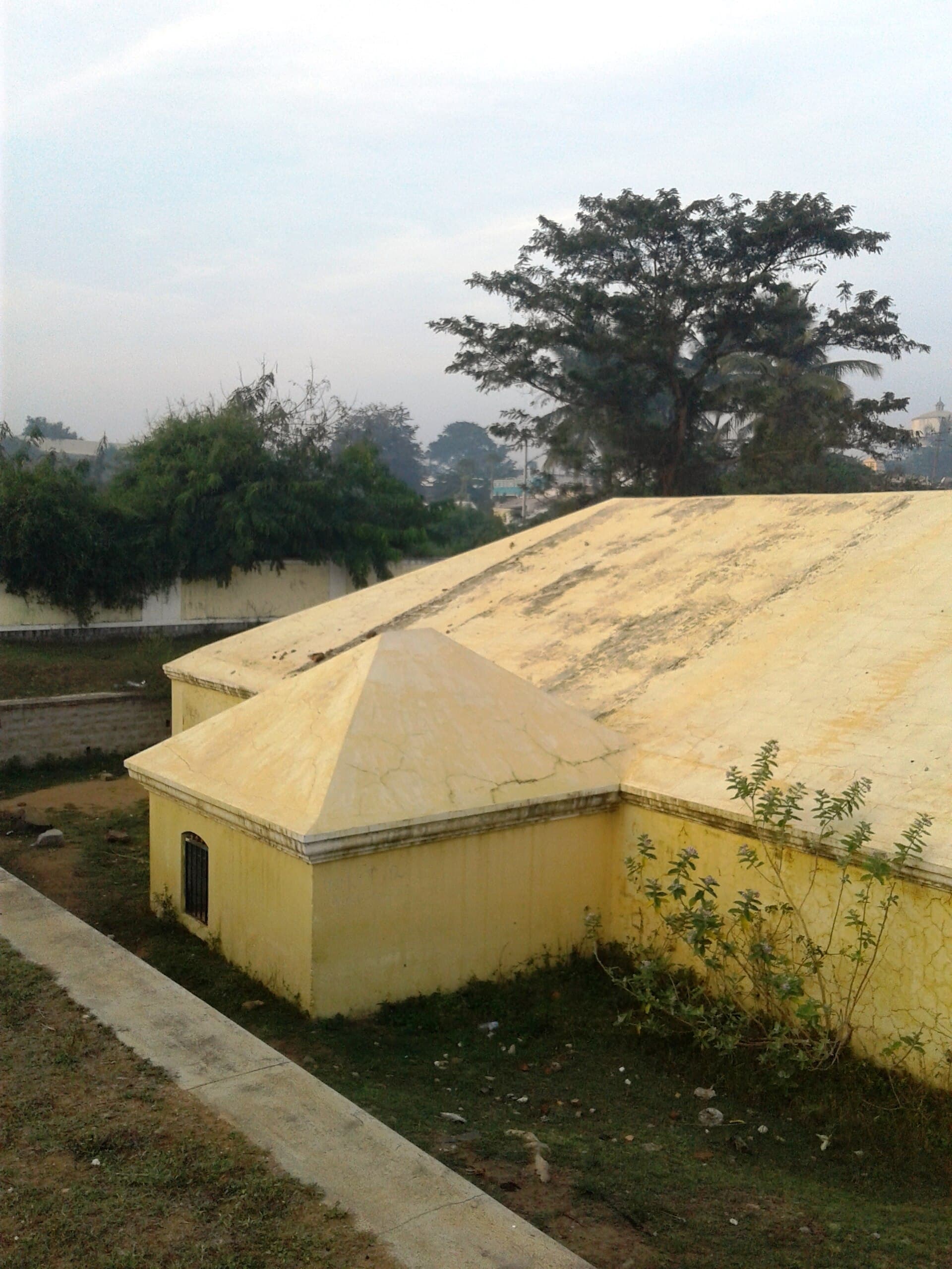 The armoury at Srirangapatna: a low, thick-walled building with a pyramidal roof, standing in open ground.