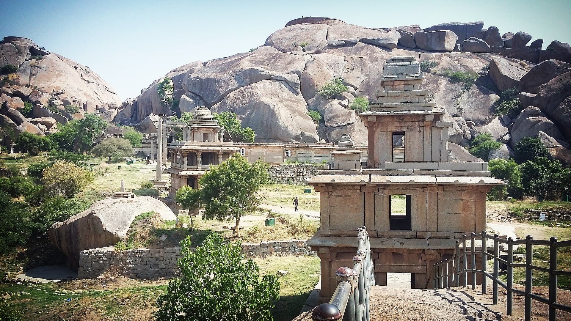 The walls of Chitradurga fort threading between huge granite boulders across a hillside.