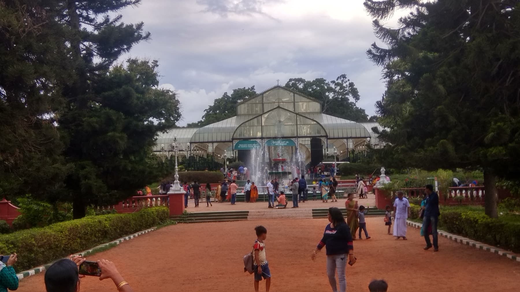 The cast-iron and glass conservatory at Lalbagh, a long barrel-vaulted glasshouse with arched end bays.
