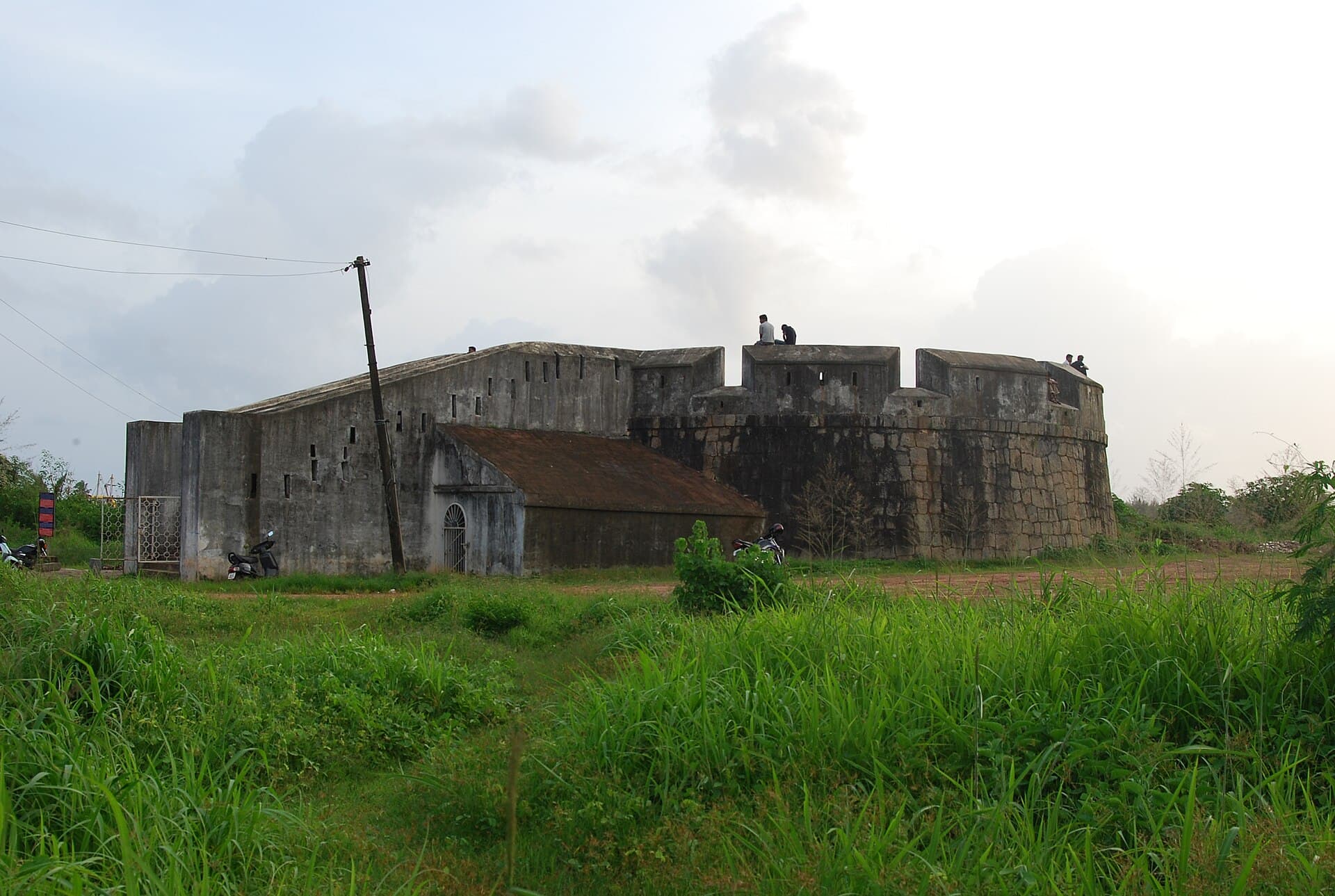 The squat Sultan Battery at Mangalore, its parapet pierced with narrow embrasures and a rounded bastion at one end.