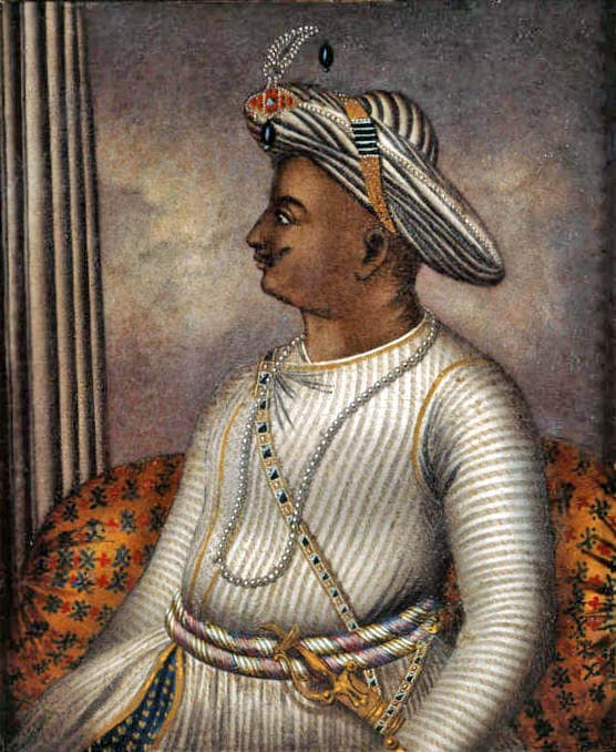 Painted portrait of Tipu Sultan in profile, wearing a striped turban with a jewelled ornament and a pearl sash.